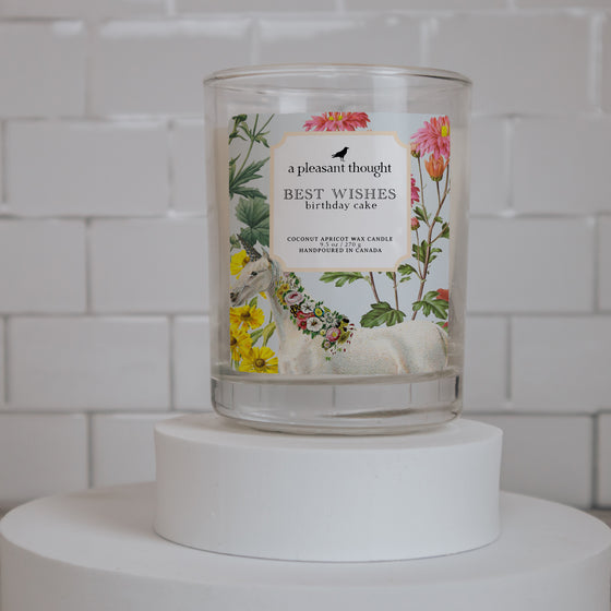coconut apricot wax candle in a classic, clear glass votive with a wooden wick