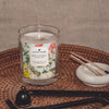 coconut apricot wax candle in a classic, clear glass votive with a wooden wick display