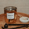 kontattam butter cake coconut apricot wax tamil candle in an elegant gold glass vessel with a wooden wick display