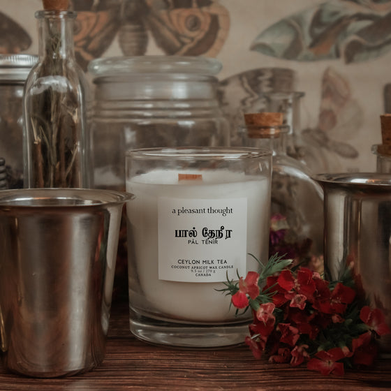 ceylon milk tea inspiration for pal tenir ceylon milk tea coconut apricot wax candle in a classic, clear glass votive with a wooden wick tamil candle notes