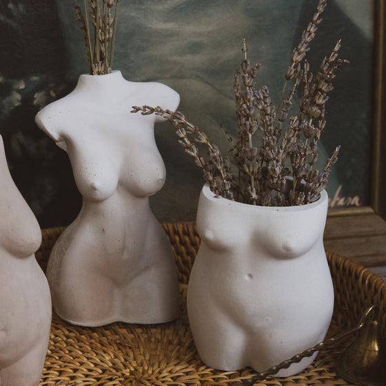 concrete voluptuous woman vase displayed