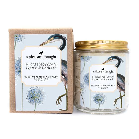 hemingway cypress and black salt Scoopable coconut apricot wax melt whipped into a clear glass jar with a gold lid and spoon 