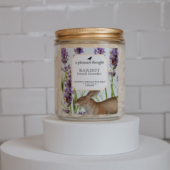 bardot french lavender Scoopable coconut apricot wax melt whipped into a clear glass jar with a gold lid and spoon