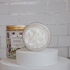 bardot french lavender Scoopable coconut apricot wax melt whipped into a clear glass jar with a gold lid and spoon open