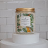 grace honeysuckle and jasmine Scoopable coconut apricot wax melt whipped into a clear glass jar with a gold lid and spoon