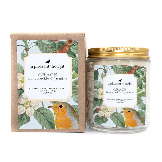 grace honeysuckle and jasmine Scoopable coconut apricot wax melt whipped into a clear glass jar with a gold lid and spoon box
