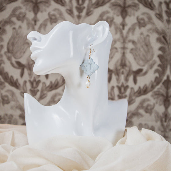 peonies on pale blue polymer clay earrings with freshwater pearl dangles monochromatic model