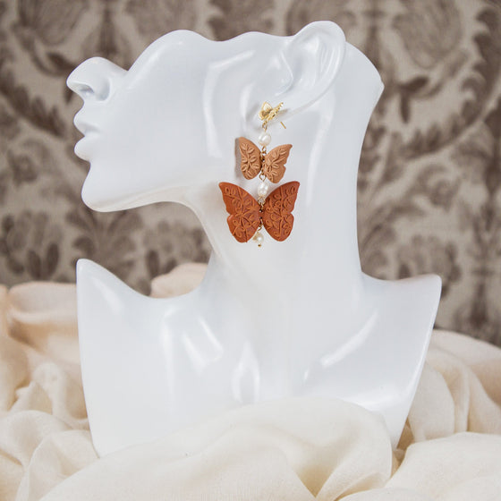 florals on shades of nude butterflies polymer clay earrings with freshwater pearls dangles monochromatic model