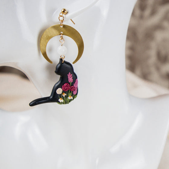 florals on black cat under brass moon polymer clay earrings with moonstone dangles