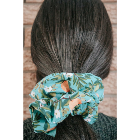 big scrunchie teal with oranges and lemons on hair