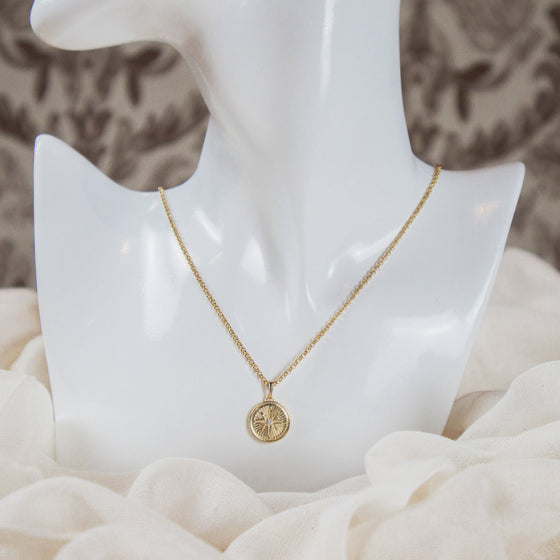 North star medallion pendant on dainty gold-filled rolo chain necklace model