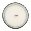 lolita salted caramel and pistachio coconut apricot wax candle in a classic, clear glass vessel with a wooden wick top