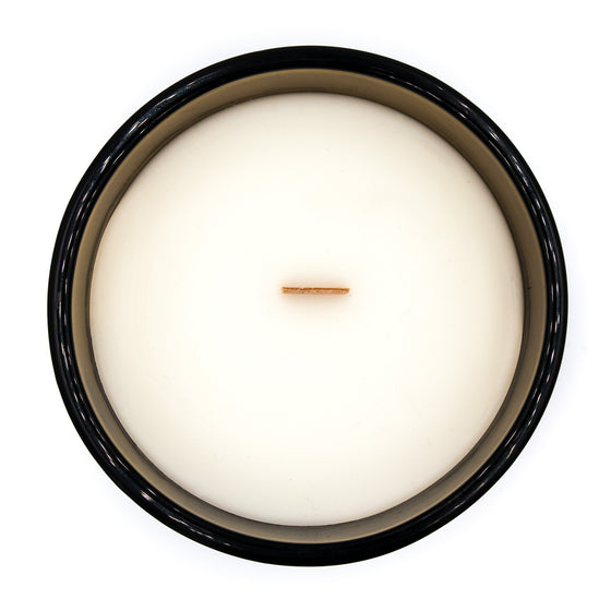 jasmine coconut apricot wax candle in an elegant gold glass vessel with a wooden wick mallikai pu tamil candle top