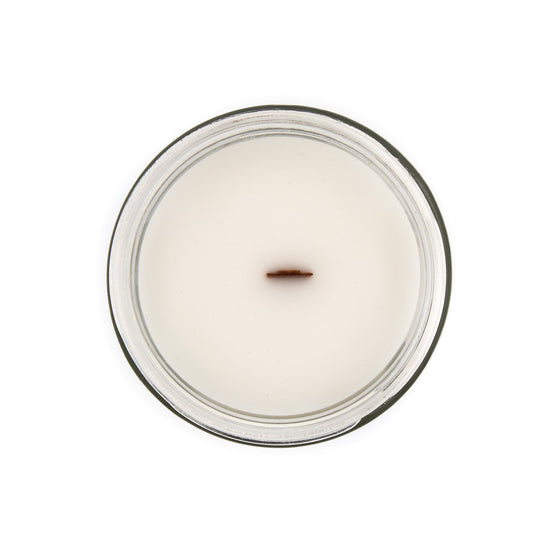 arccanai puja coconut apricot wax candle in a classic, clear glass votive with a wooden wick tamil candle top