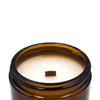 dawn cashmere and almond creme coconut apricot wax candle in an amber glass jar with a wooden wick and lid  top side