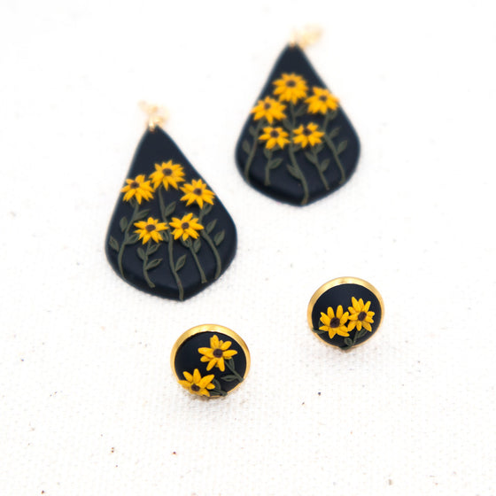 Polymer clay earrings black-eyed susan flowers on black teardrop dangles separated