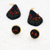    IMG_6020  800 × 800px  Polymer clay earrings red amaryllis flowers on black teardrop dangles separated