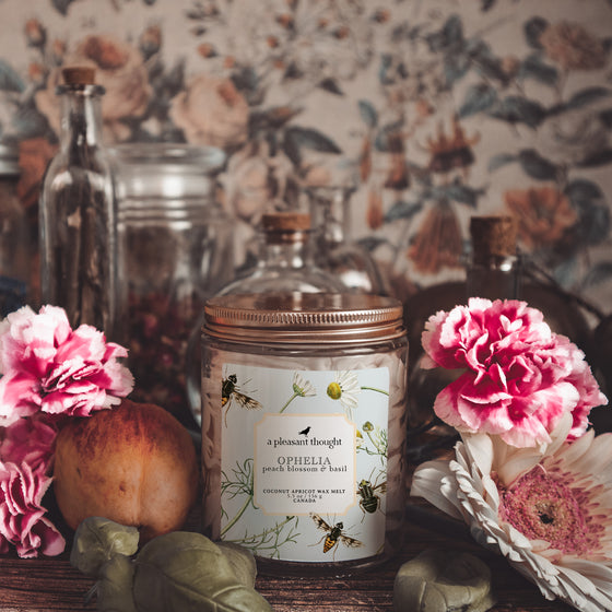 ophelia peach blossom and basil Scoopable coconut apricot wax melt whipped into a clear glass jar with a gold lid and spoon notes