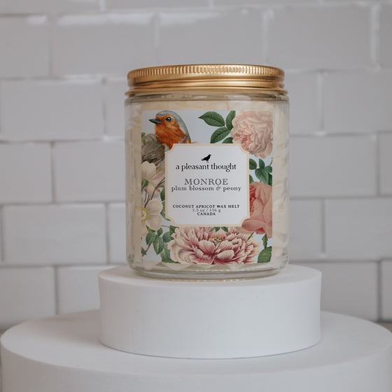 monroe plum blossom and peony Scoopable coconut apricot wax melt whipped into a clear glass jar with a gold lid and spoon