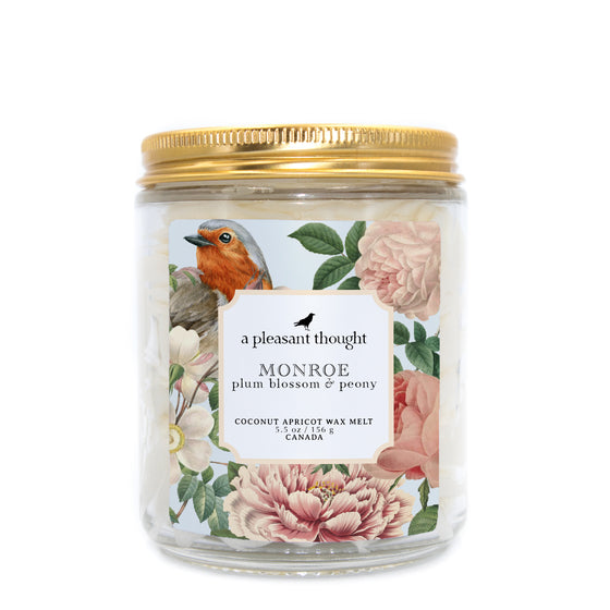 monroe plum blossom and peony Scoopable coconut apricot wax melt whipped into a clear glass jar with a gold lid and spoon a pleasant thought