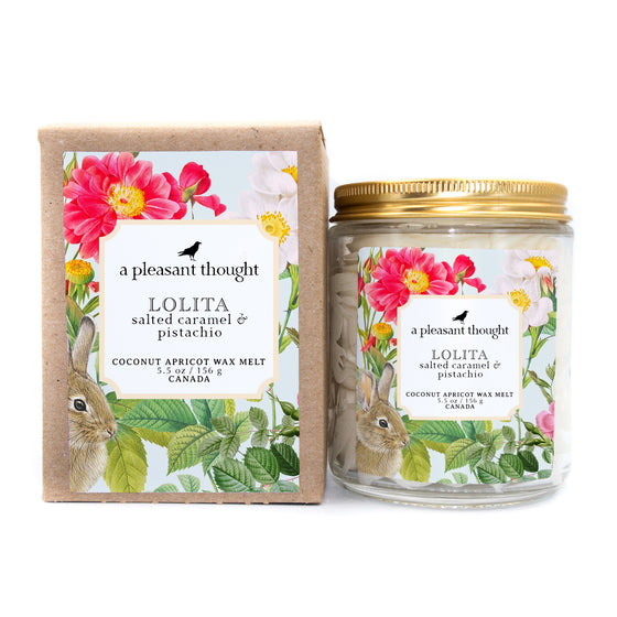 lolita salted caramel and pistachio Scoopable coconut apricot wax melt whipped into a clear glass jar with a gold lid and spoon box
