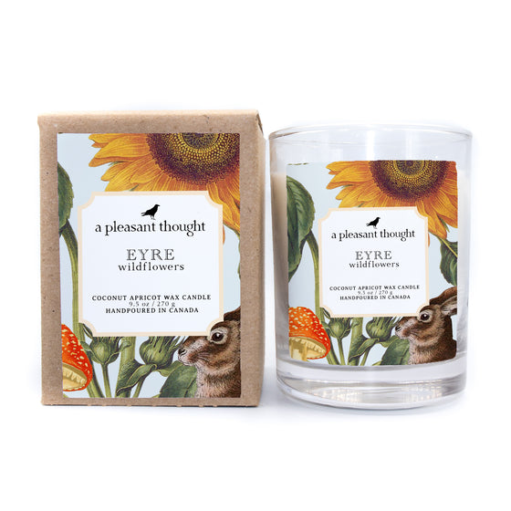 eyre wildflowers coconut apricot wax candle in a clear glass vessel with a wooden wick box