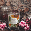eyre wildflowers coconut apricot wax candle in a clear glass vessel with a wooden wick notes