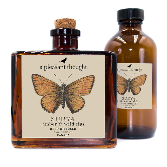 surya amber and wild figs Fragranced diffuser oil housed in an amber glass, apothecary bottle with rattan reed package