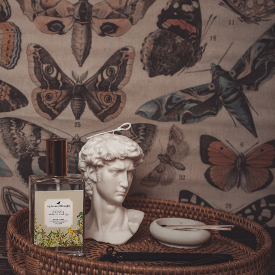 surya amber and wild figs Fragranced room and linen spray housed in a decorative glass bottle with a gold lid display