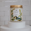 atticus bergamot and oakmoss Scoopable coconut apricot wax melt whipped into a clear glass jar with a gold lid and spoon 