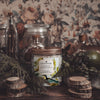 atticus bergamot and oakmoss Scoopable coconut apricot wax melt whipped into a clear glass jar with a gold lid and spoon notes