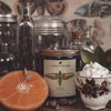 nori cardamom and orange creme luxurious, coconut apricot wax candle in an amber glass jar with a wooden wick and lid notes
