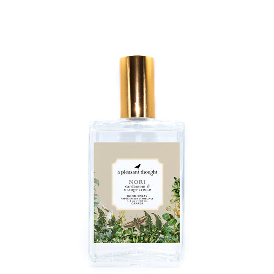 nori cardamom and orange creme Fragranced room and linen spray housed in a decorative glass bottle with a gold lid a pleasant thought