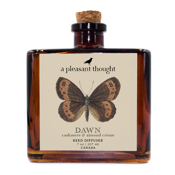 dawn cashmere and almond creme Fragranced diffuser oil housed in an amber glass, apothecary bottle with rattan reeds a pleasant thought