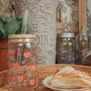 handpainted peaches on a beer can glass with lid and straw