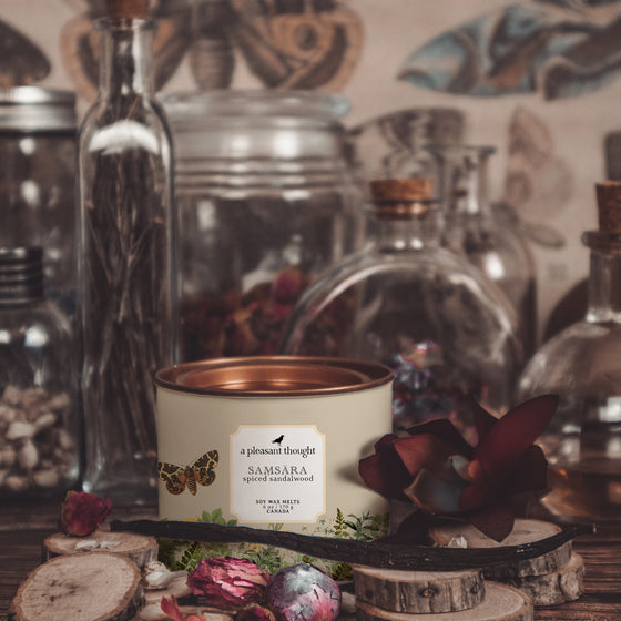 samsara spiced sandalwood soy wax melts housed in an antique gold tin notes